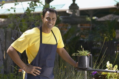 Team member using protective gear during garden maintenance